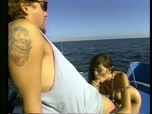 brunette sucking guy big dick on the boat