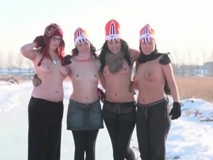 Four ladies naked while ice skating in a field