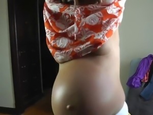 Sexy  pregnant girl trying on dresses