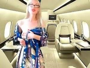 Provoking blonde flight attendant exposes her slim body on