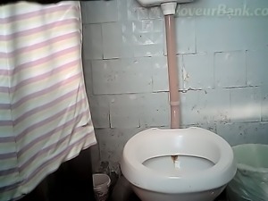 Slender pale skin hottie pisses sideways in the toilet room
