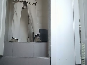 Lovely white lady in strict office dress pisses in the toilet room