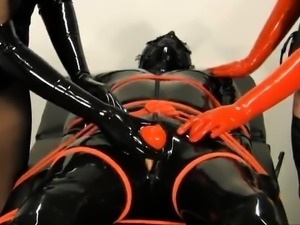 Horny slave in latex gets his hard cock teased and pleased