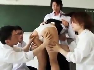 Busty Asian teacher enjoys a gang of cocks in the classroom