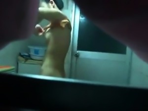 Lovely Asian babe exposes her perky titties on hidden cam