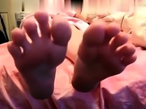 Sweet asian hottie with foot fetish doing footjob in POV