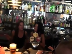 Two sensual babes fucked rough by a group of guys in a bar