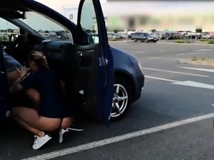 Amateur milf with a lovely ass blows a cock in a parking lot