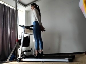 Bound and gagged Asian babe walks on treadmill in high heels